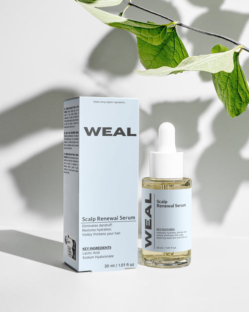 WEAL Scalp Renewal Serum bottle and packaging on a light background with leaves.